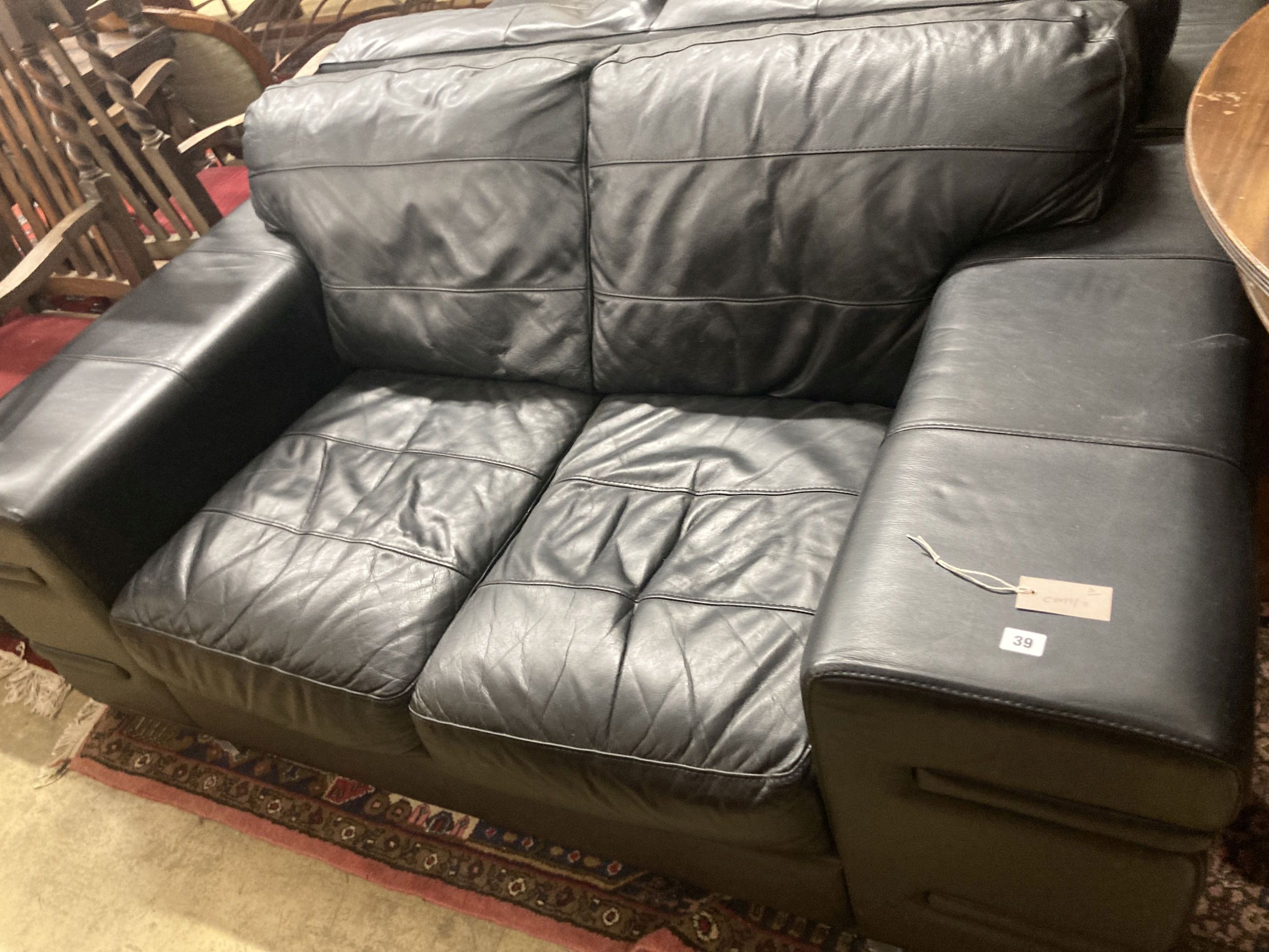 A pair of contemporary black leather two seater sofas, length 166cm, depth 92cm, height 70cm